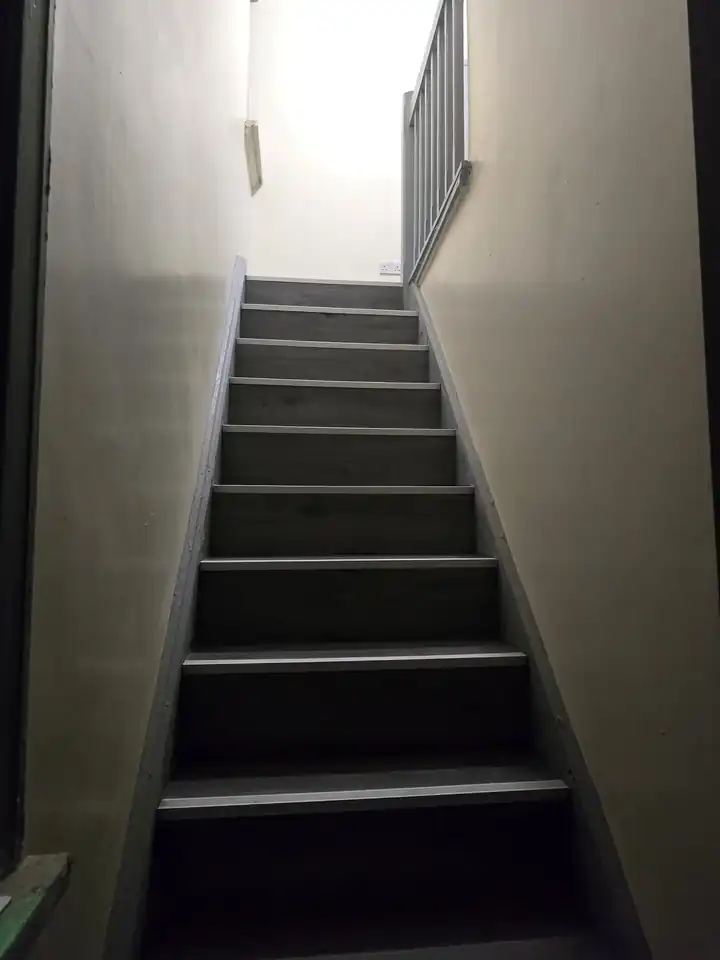 Staircase after installation of dark finished treads and safety nosing